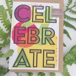 plantable wildflower seed card with large text filling front of card in capital letters celebrate in neon colours