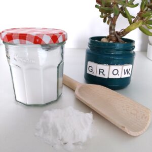 bicarbonate of soda loose next to a preloved glass jar filled with bicarbonate of soda